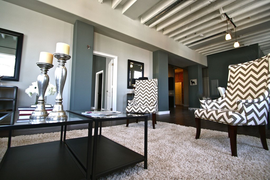 a living room with a table and chairs